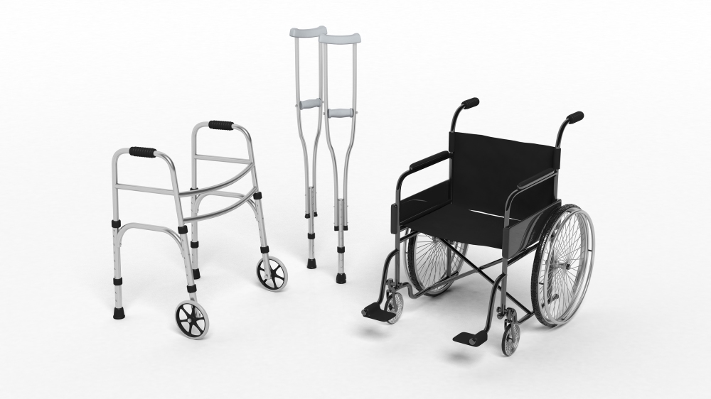 Black disability wheelchair, crutch and metallic walker isolated